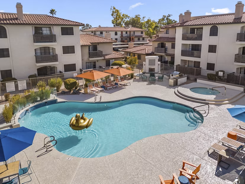 Resort-style pool with loungers at Chazal Scottsdale Apartments, offering luxury relaxation spaces