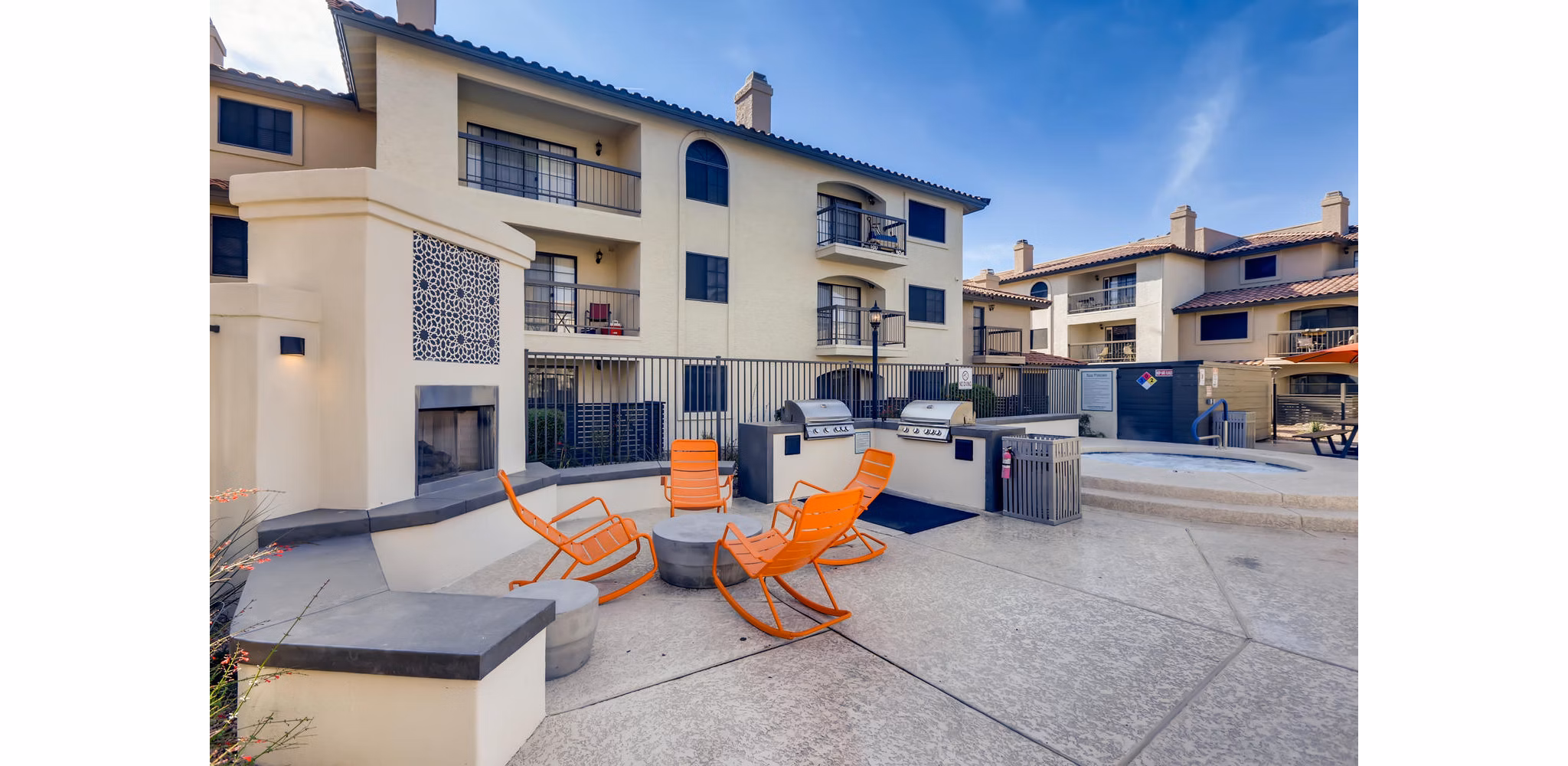 Outdoor grilling area with modern barbecue stations at Chazal Scottsdale Apartments