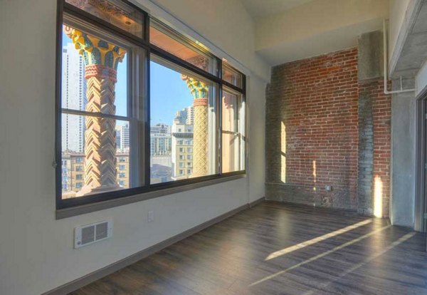 Bedroom with elegant decor and large windows in The Wilson Building Apartments
