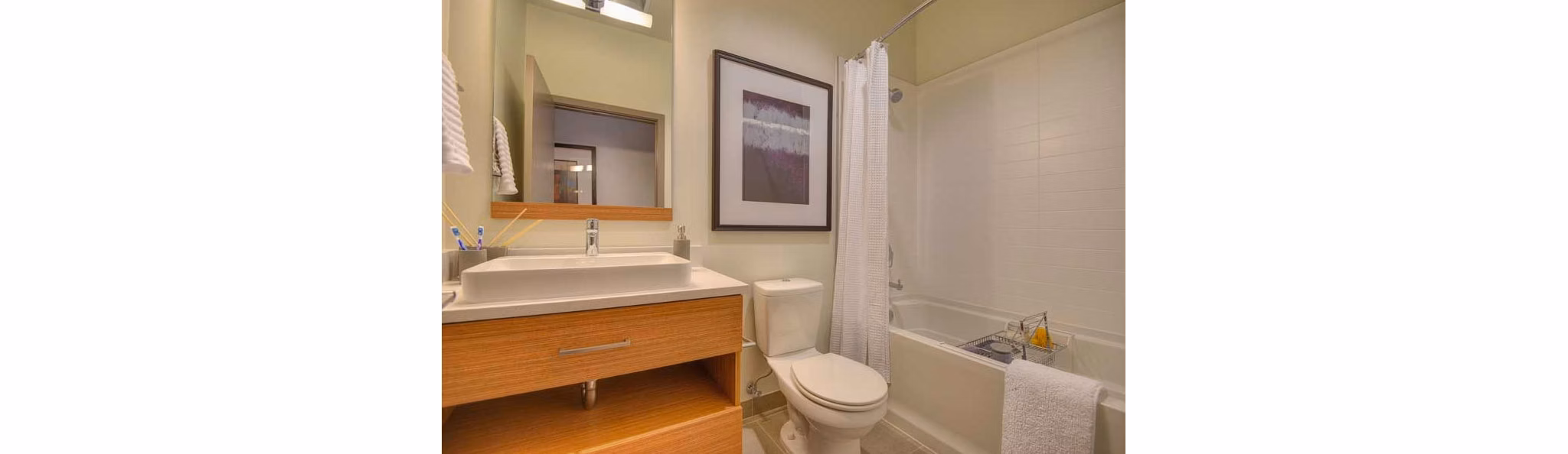 Modern bathroom with marble countertops and sleek fixtures at The Wilson Building Apartments