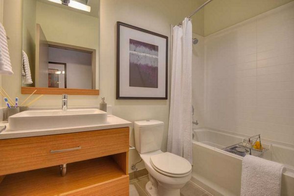 Modern bathroom with marble countertops and sleek fixtures at The Wilson Building Apartments