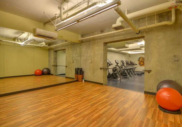 State-of-the-art fitness center at The Wilson Building Apartments, offering luxury workout spaces and modern equipment for residents