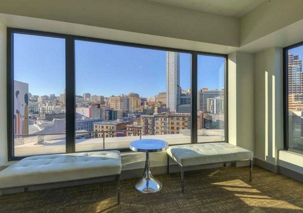Spacious living room with modern decor and large windows in The Wilson Building Apartments