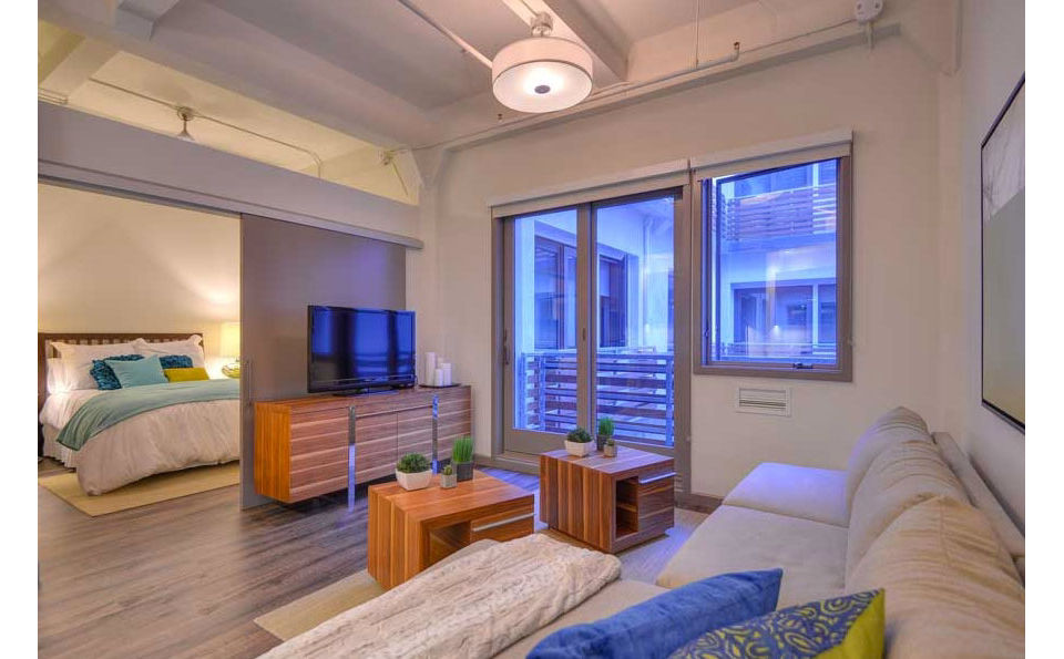 Spacious living room with modern decor at The Wilson Building Apartments
