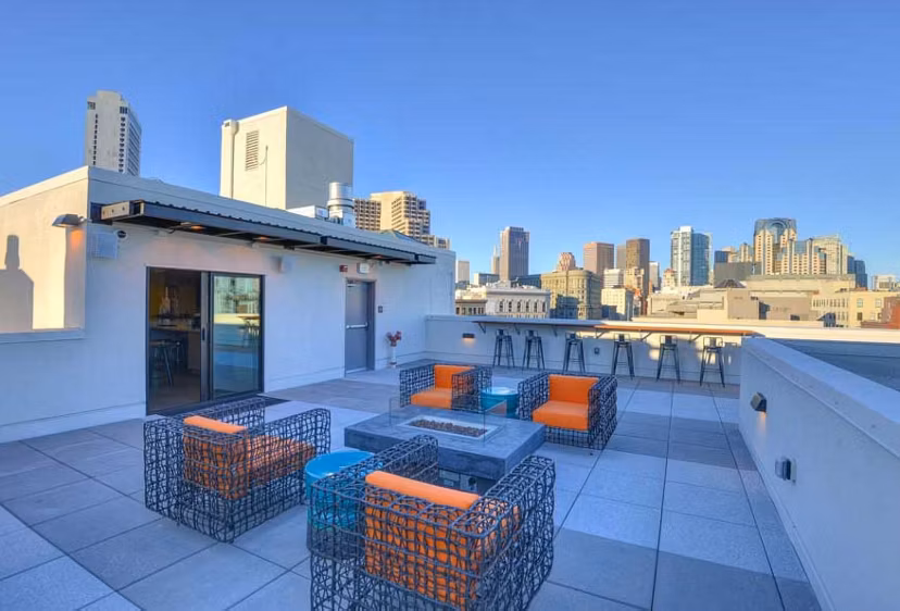Fire pit surrounded by cozy seating area at The Wilson Building Apartments