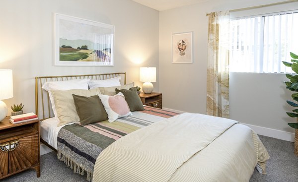Cozy bedroom with modern furniture at The Ridge at Mountain View Apartments, perfect for comfortable living in luxury settings