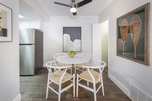 Dining area featuring modern furnishings and large windows at The Ridge at Mountain View Apartments