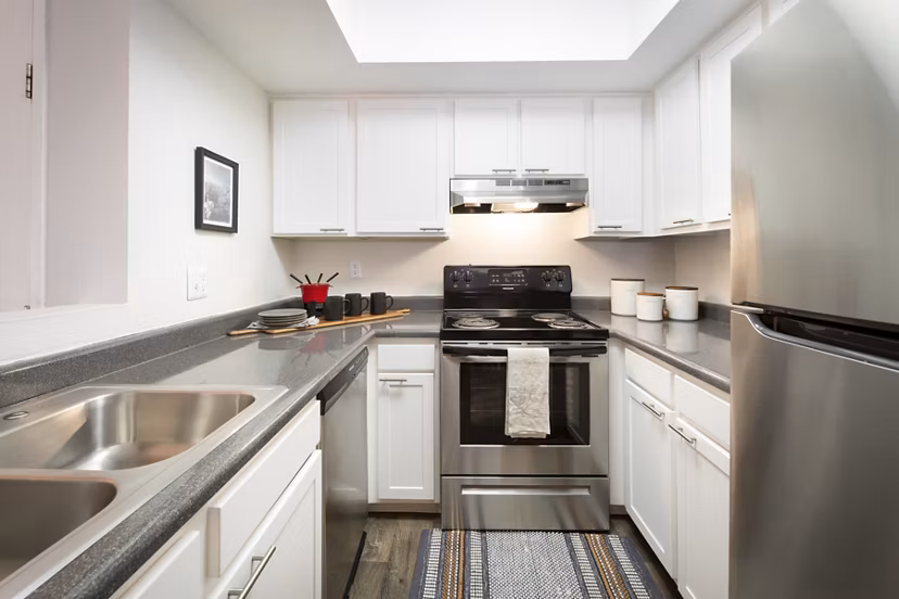 Modern kitchen with stainless steel appliances at The Ridge at Mountain View Apartments, offering a stylish living experience