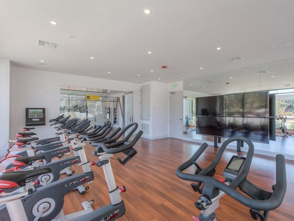 Modern fitness room with state-of-the-art equipment at 121 Tasman Apartments