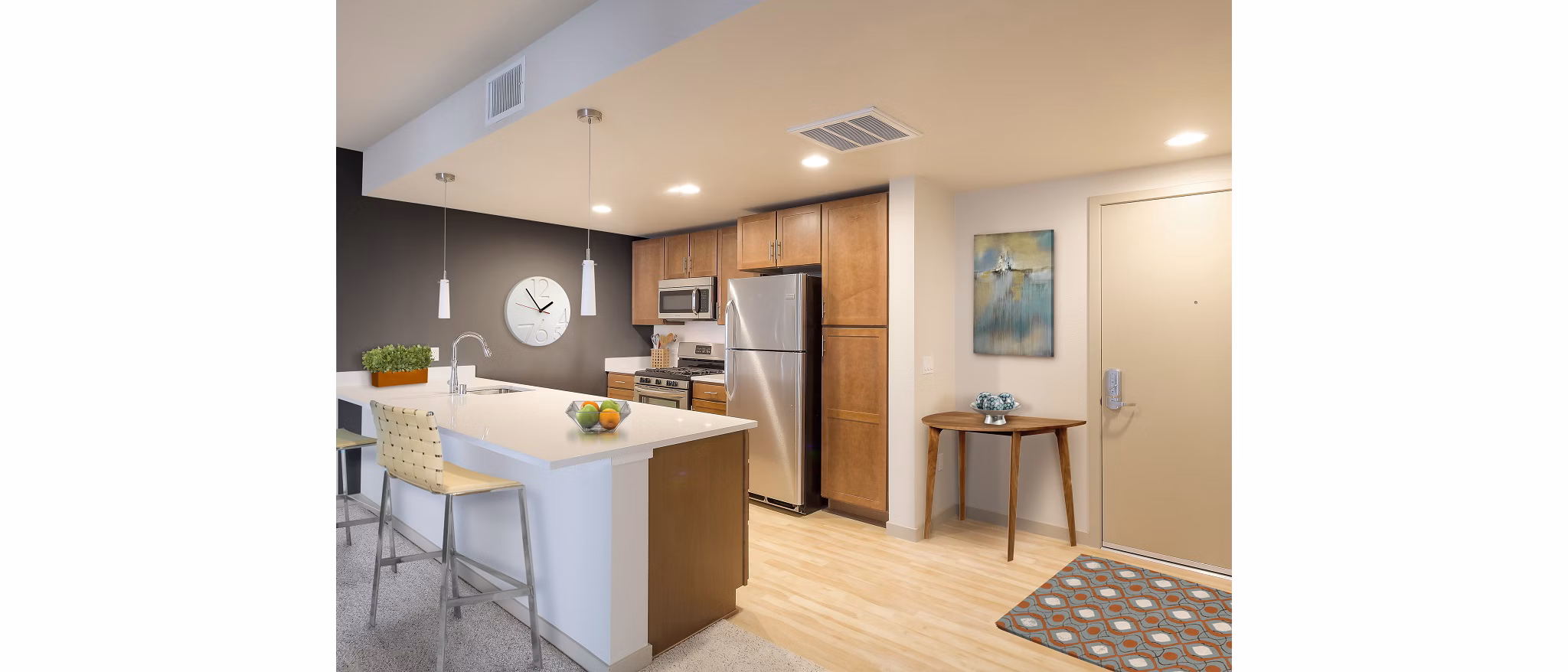 Modern kitchen with stainless steel appliances and quartz countertops at 121 Tasman Apartments