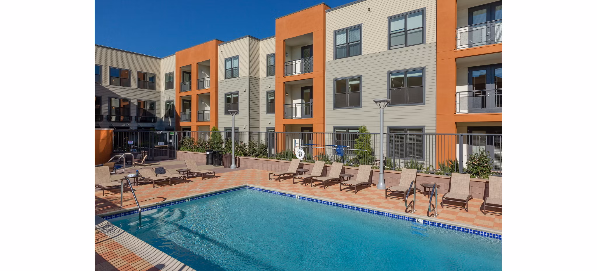 Resort-style pool with lush landscaping at 121 Tasman Apartments