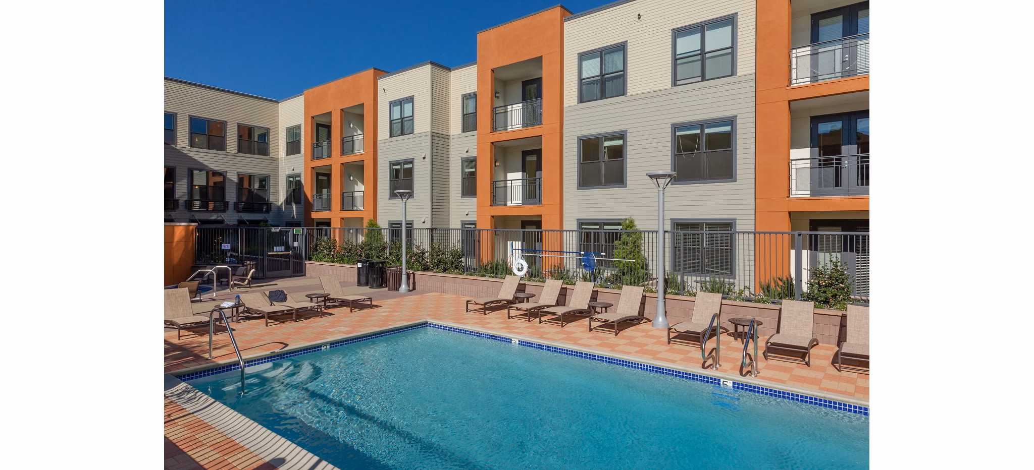 Resort-style pool with lush landscaping at 121 Tasman Apartments