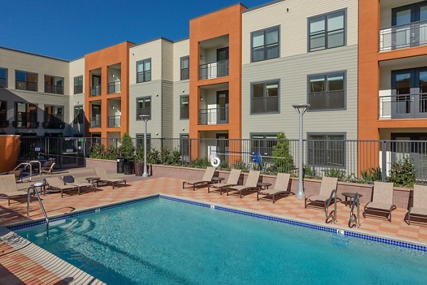 Resort-style pool with lush landscaping at 121 Tasman Apartments