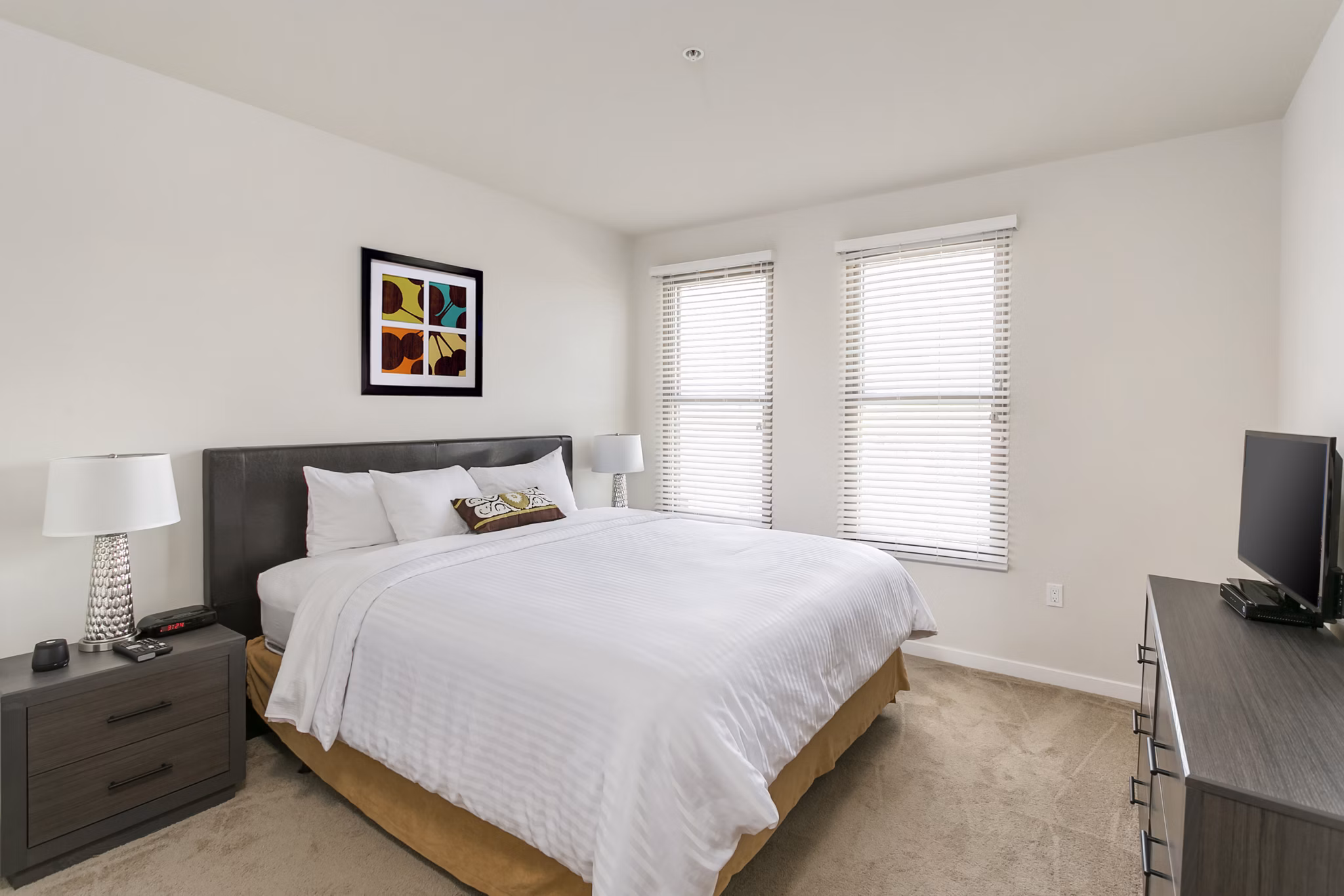 Spacious bedroom with contemporary decor in mResidences Redwood City Apartments