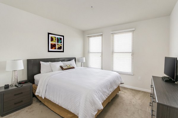 Spacious bedroom with contemporary decor in mResidences Redwood City Apartments