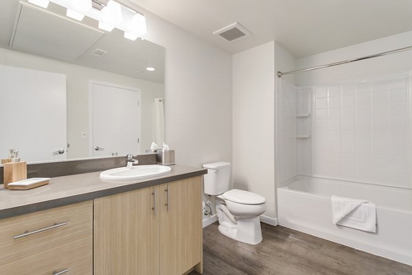 Elegant bathroom with marble countertops and modern fixtures at mResidences Redwood City Apartments