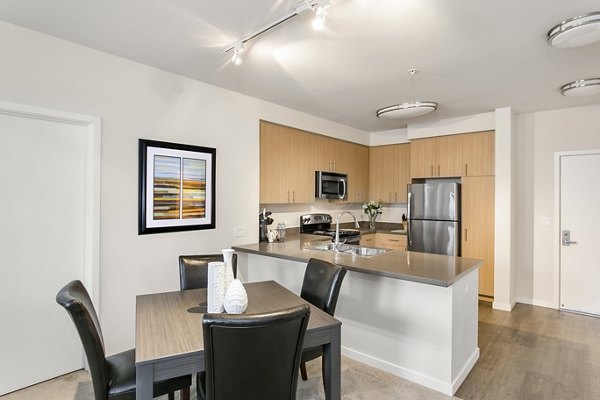 Dining room featuring elegant dining set and modern lighting at mResidences Redwood City Apartments