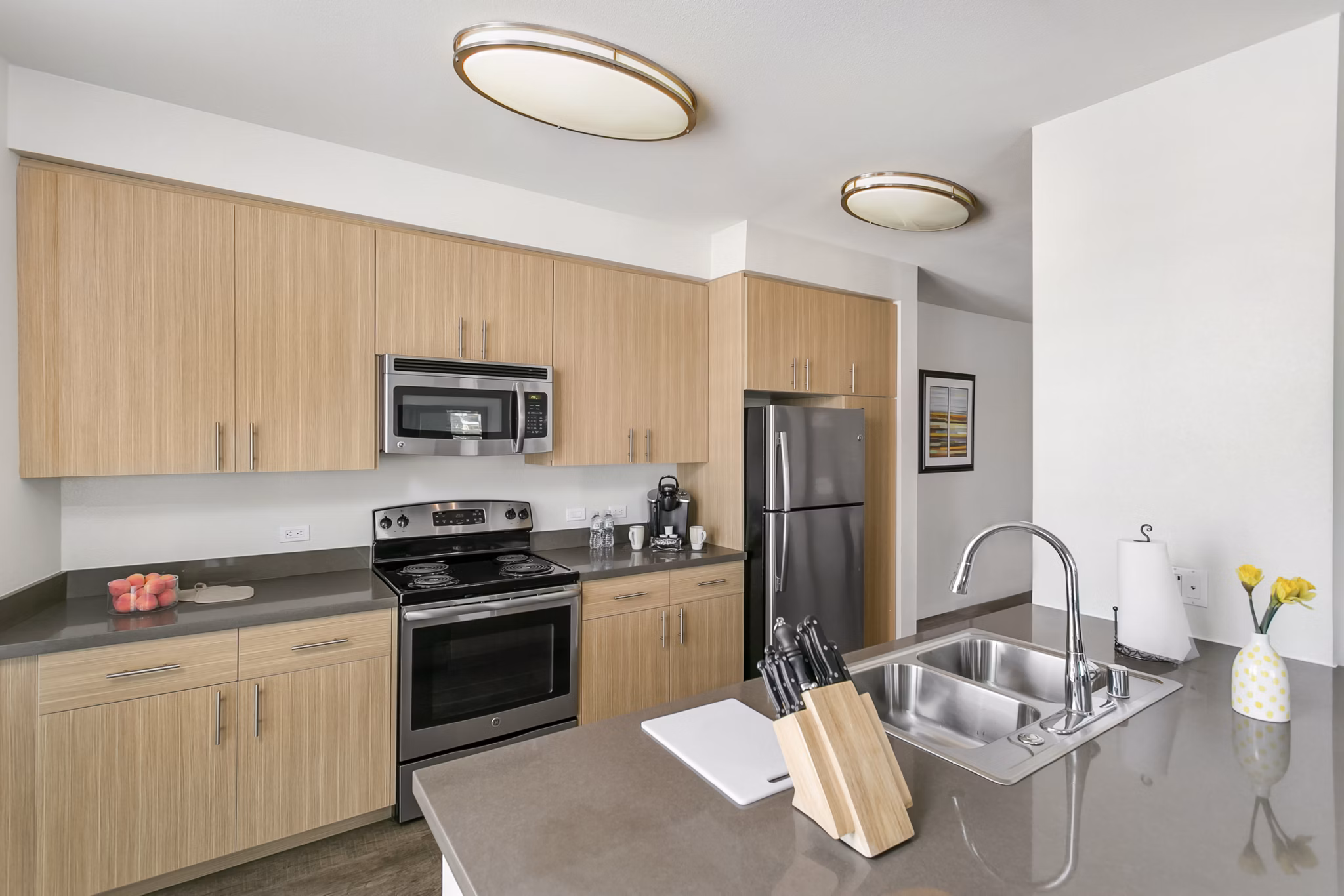 Modern kitchen with stainless steel appliances in mResidences Redwood City Apartments