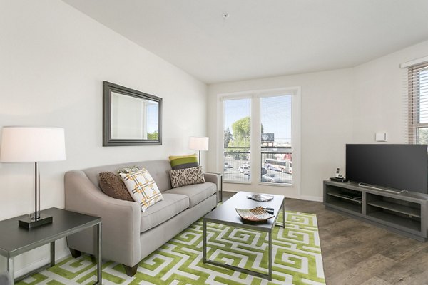 Spacious living room with contemporary furnishings in mResidences Redwood City Apartments