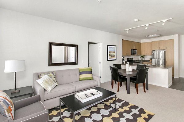 Living room featuring modern decor and natural light at mResidences Redwood City Apartments