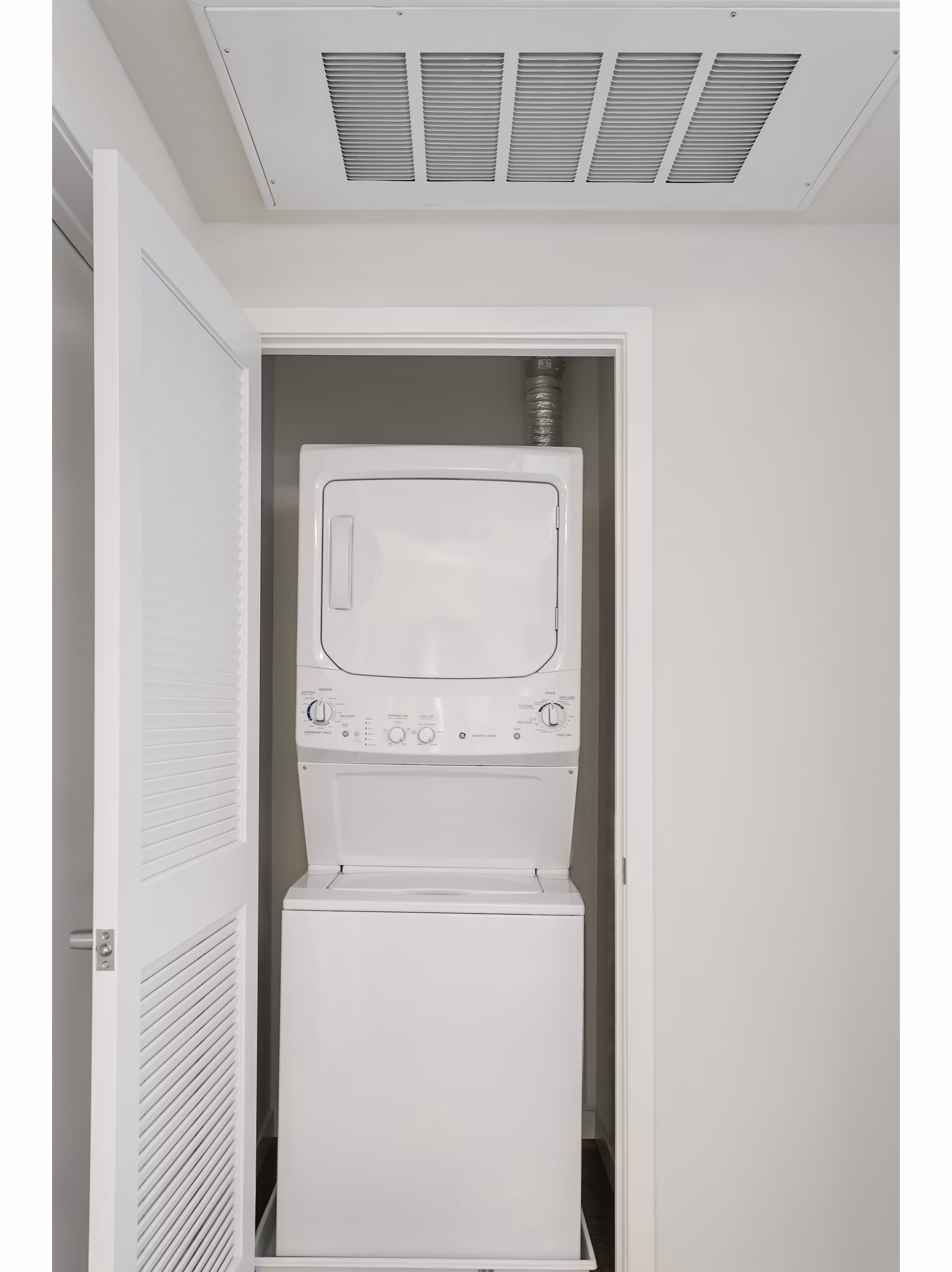 Laundry room with modern appliances at mResidences Redwood City Apartments