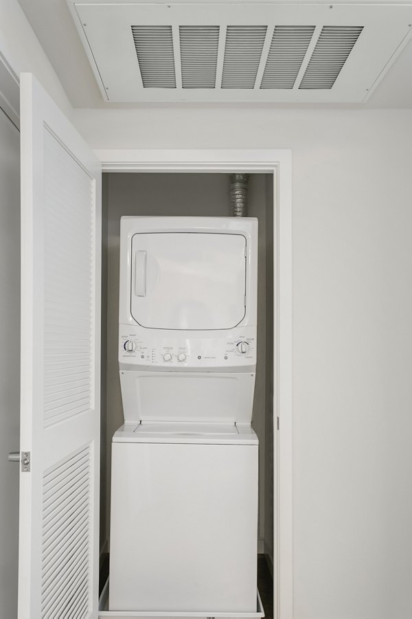 Laundry room with modern appliances at mResidences Redwood City Apartments