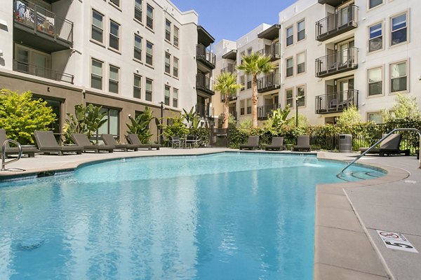 Pool featuring modern design and lounge chairs at mResidences Redwood City Apartments