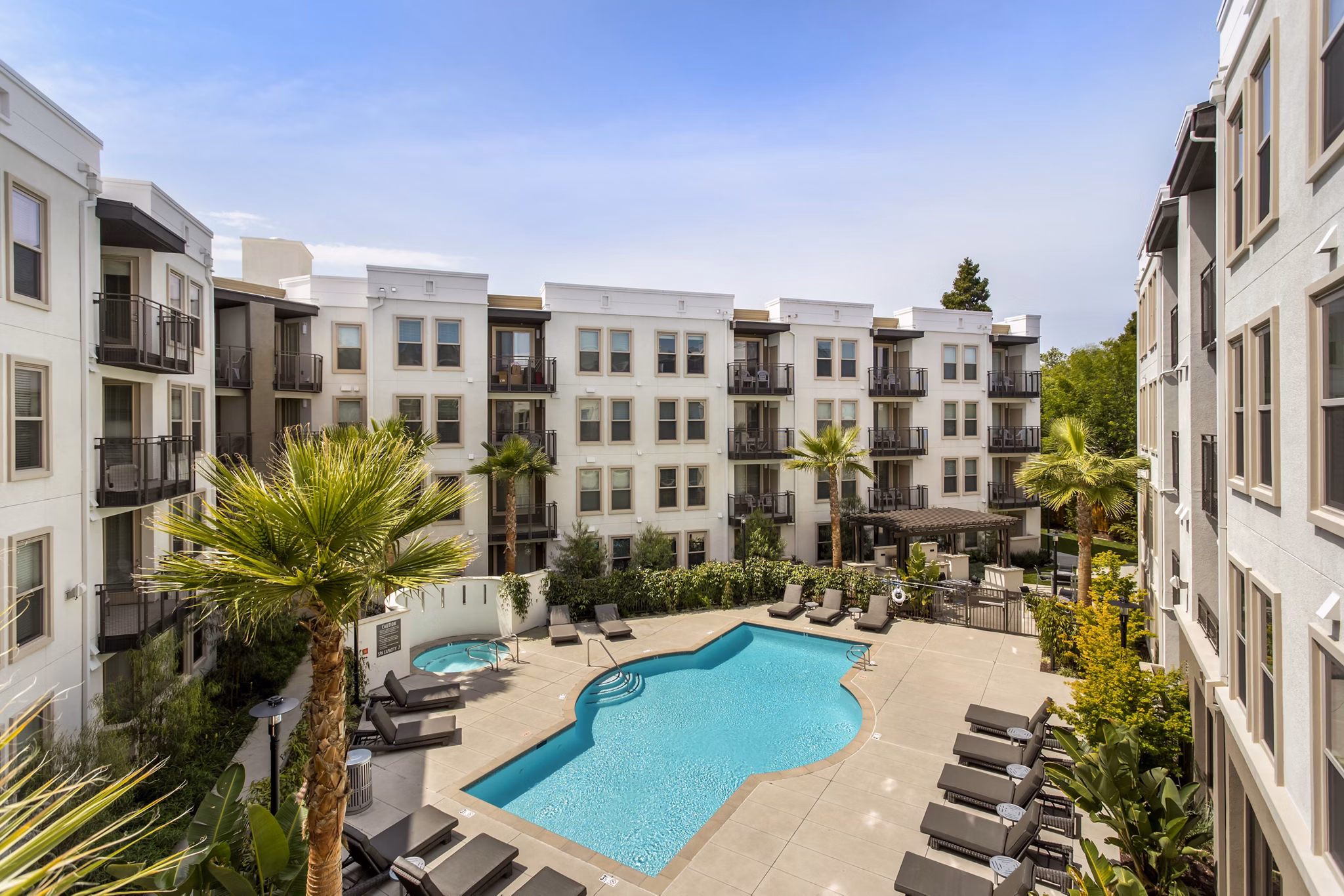 Luxury pool with cabanas at mResidences Redwood City Apartments offering relaxation and ambience for residents