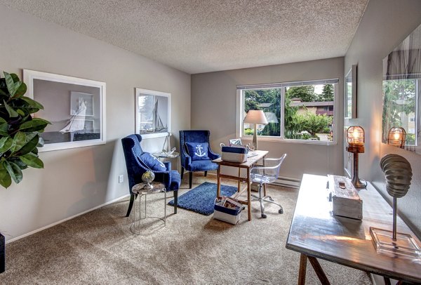 Bright kitchen with stainless steel appliances and island at Central Park East Apartments