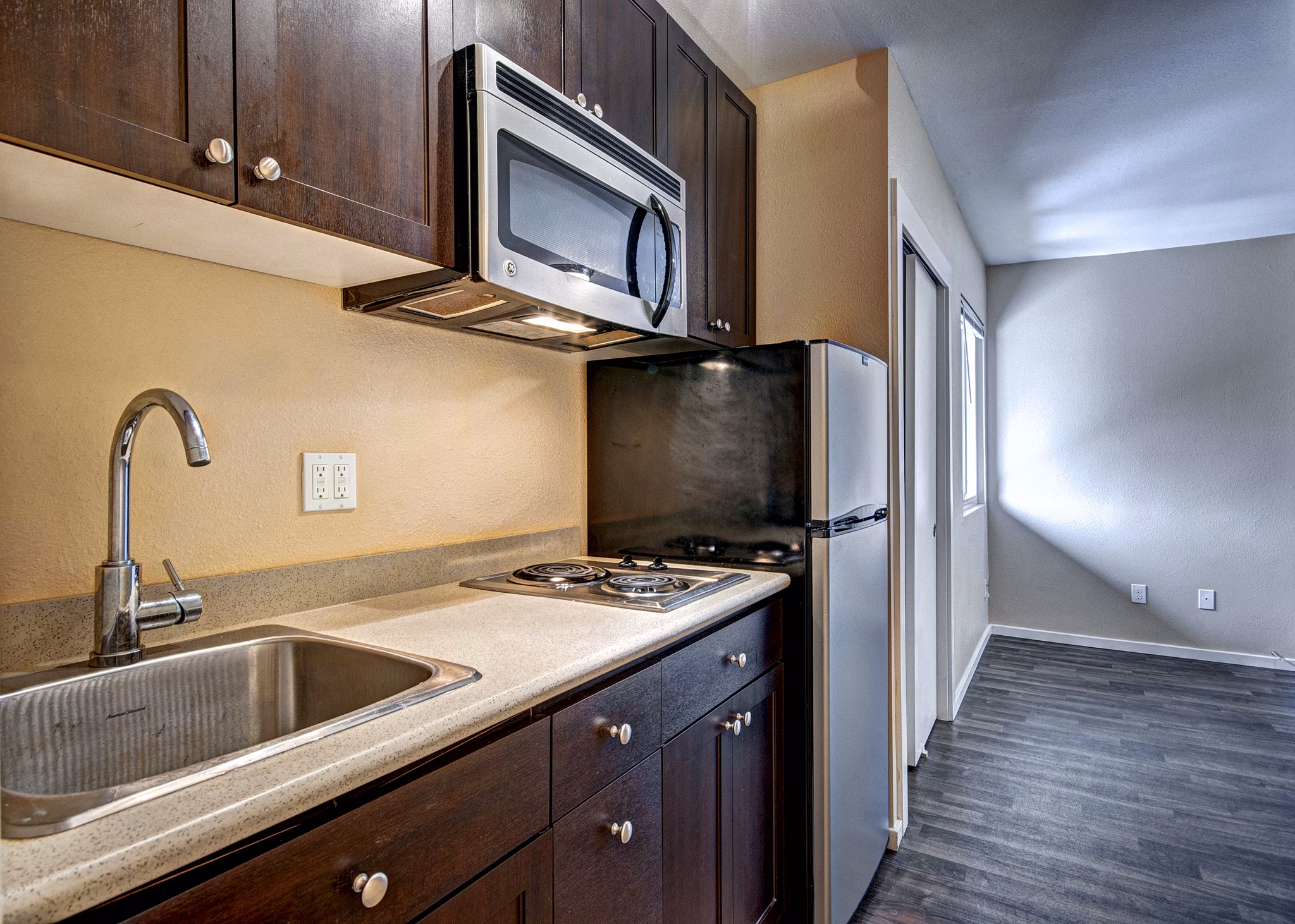 Modern kitchen with stainless steel appliances at Central Park East Apartments