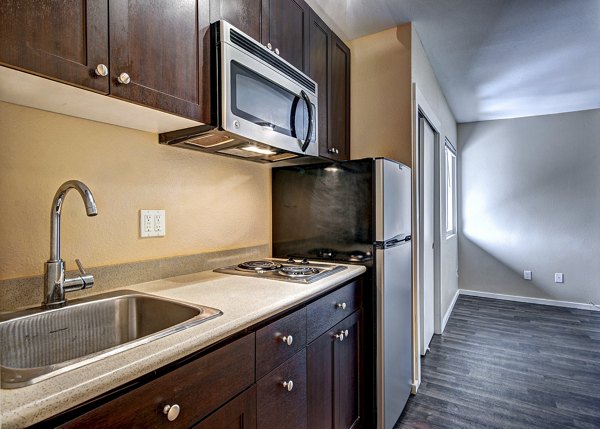 Modern kitchen with stainless steel appliances at Central Park East Apartments