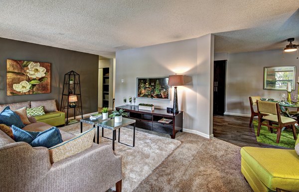 Cozy living room with modern decor and natural light at Central Park East Apartments