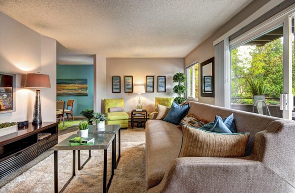 Spacious living room with modern decor in Central Park East Apartments