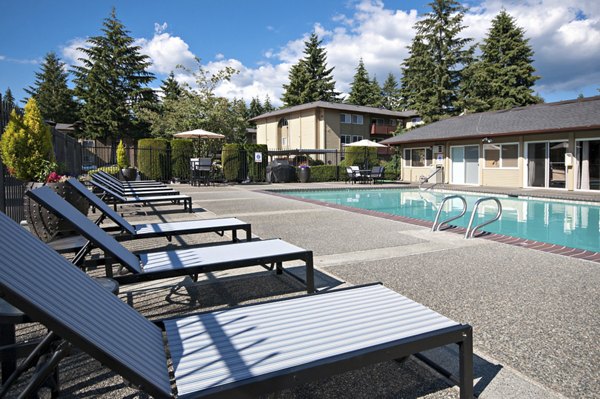 Luxury pool with sleek lounge chairs at Central Park East Apartments