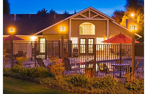Relaxing poolside at Eight Towncenter Apartments with sun loungers and landscaped views