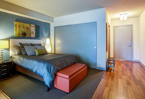 Bedroom interior featuring elegant decor and natural lighting at Equinox Apartments