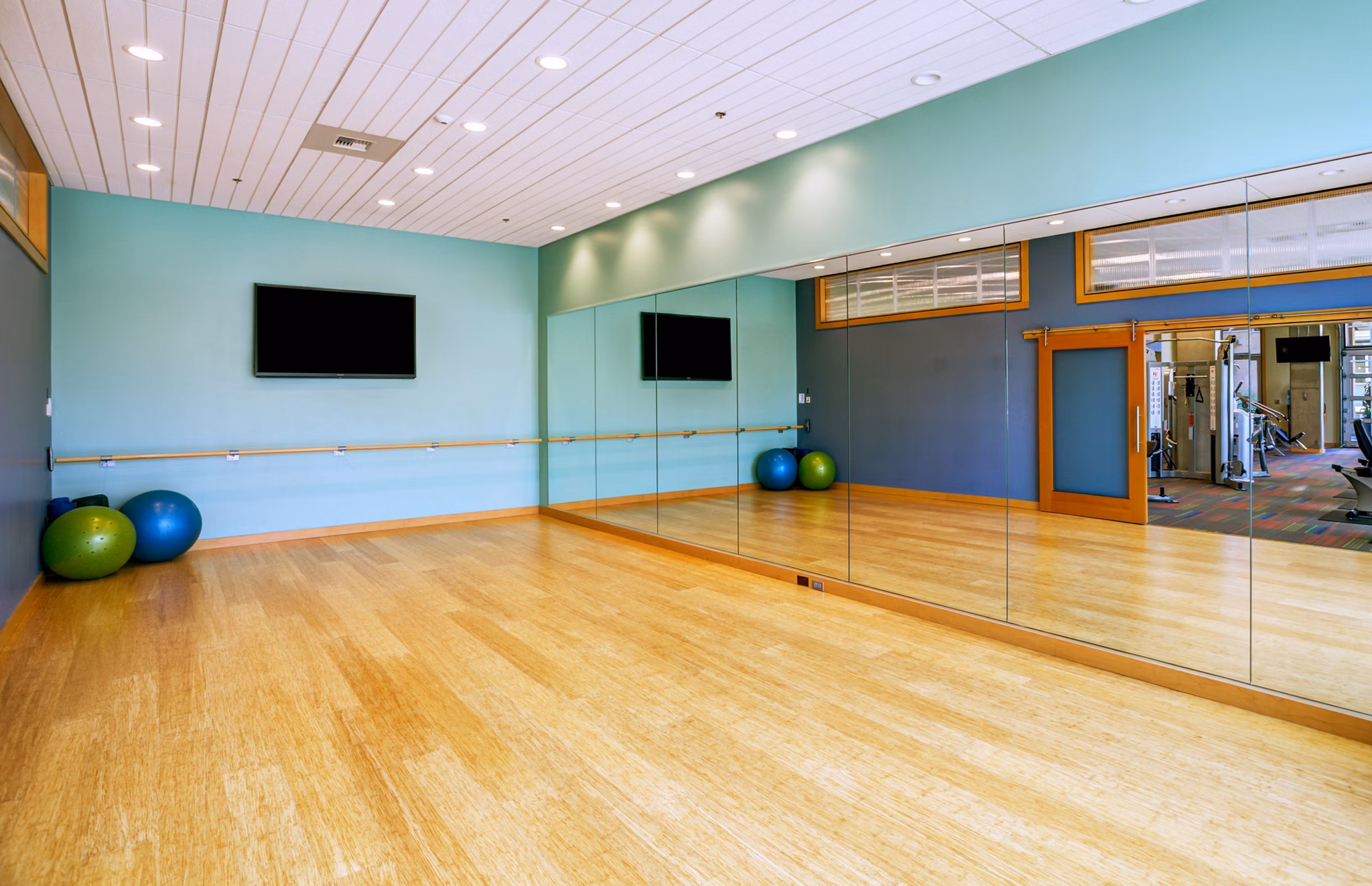 State-of-the-art fitness center with cardio and strength training equipment at Equinox Apartments