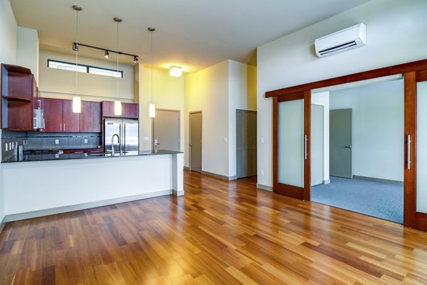 Modern kitchen with stainless steel appliances in Equinox Apartments