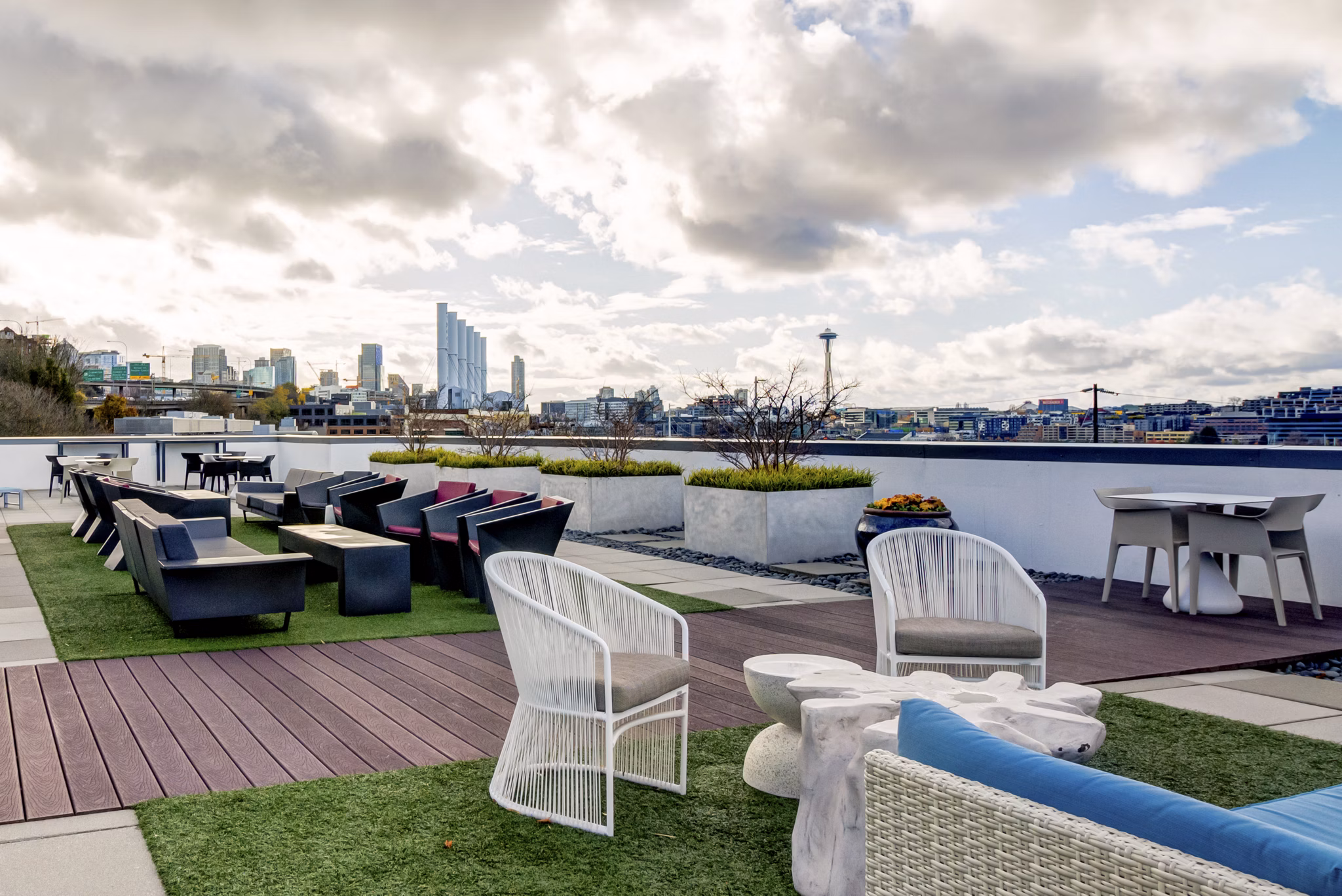 Luxurious rooftop patio offering skyline views at Equinox Apartments, perfect for relaxation and social gatherings in urban living