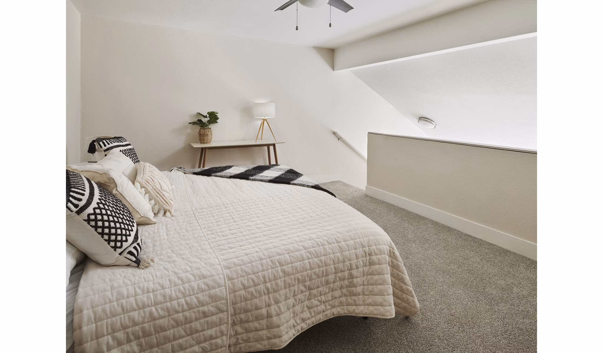 Bedroom with modern decor and large windows at The Woodlands Apartments, luxury living by Greystar