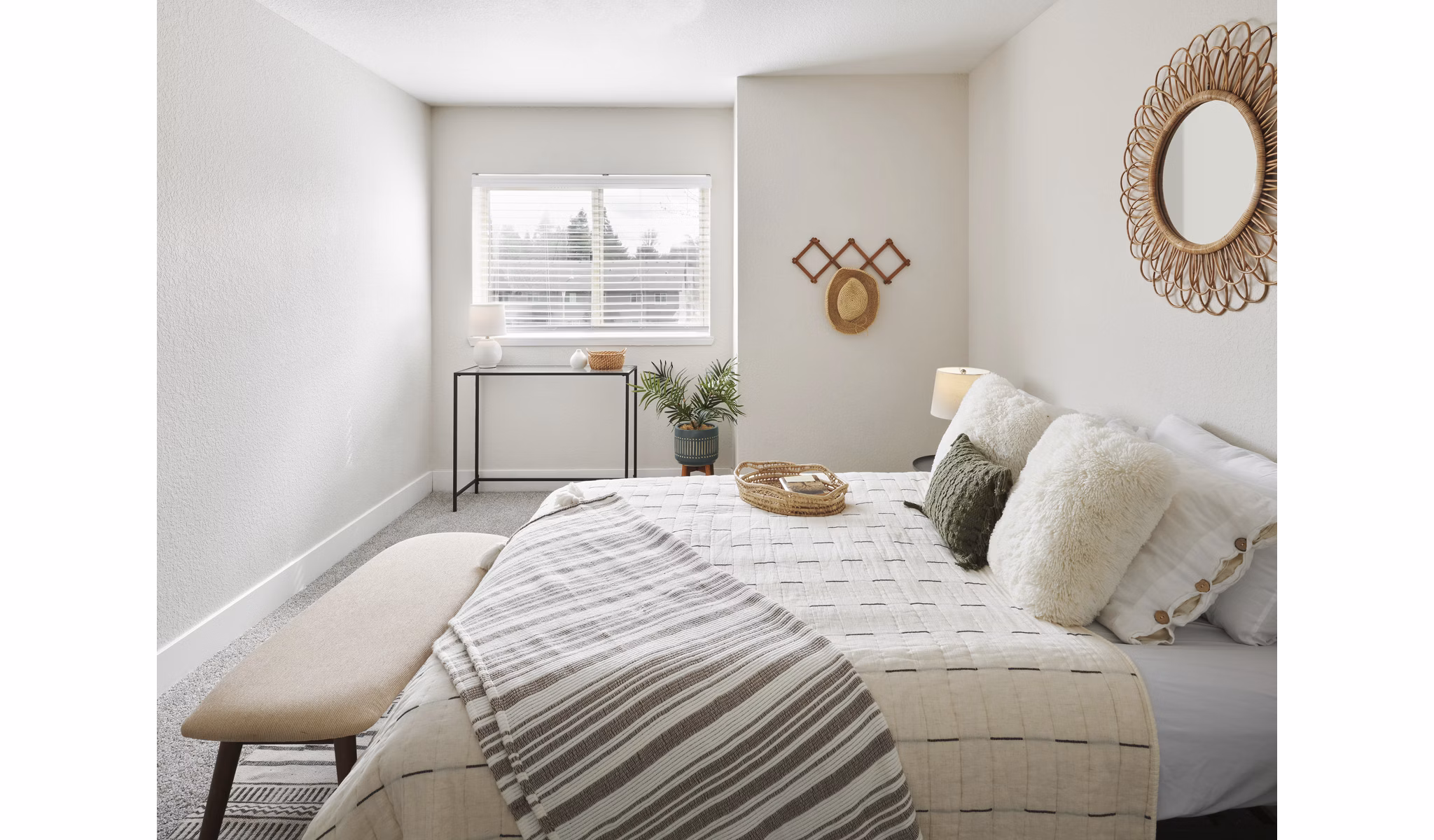 Serene bedroom with modern decor featuring a plush bed at The Woodlands Apartments