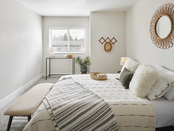 Serene bedroom with modern decor featuring a plush bed at The Woodlands Apartments