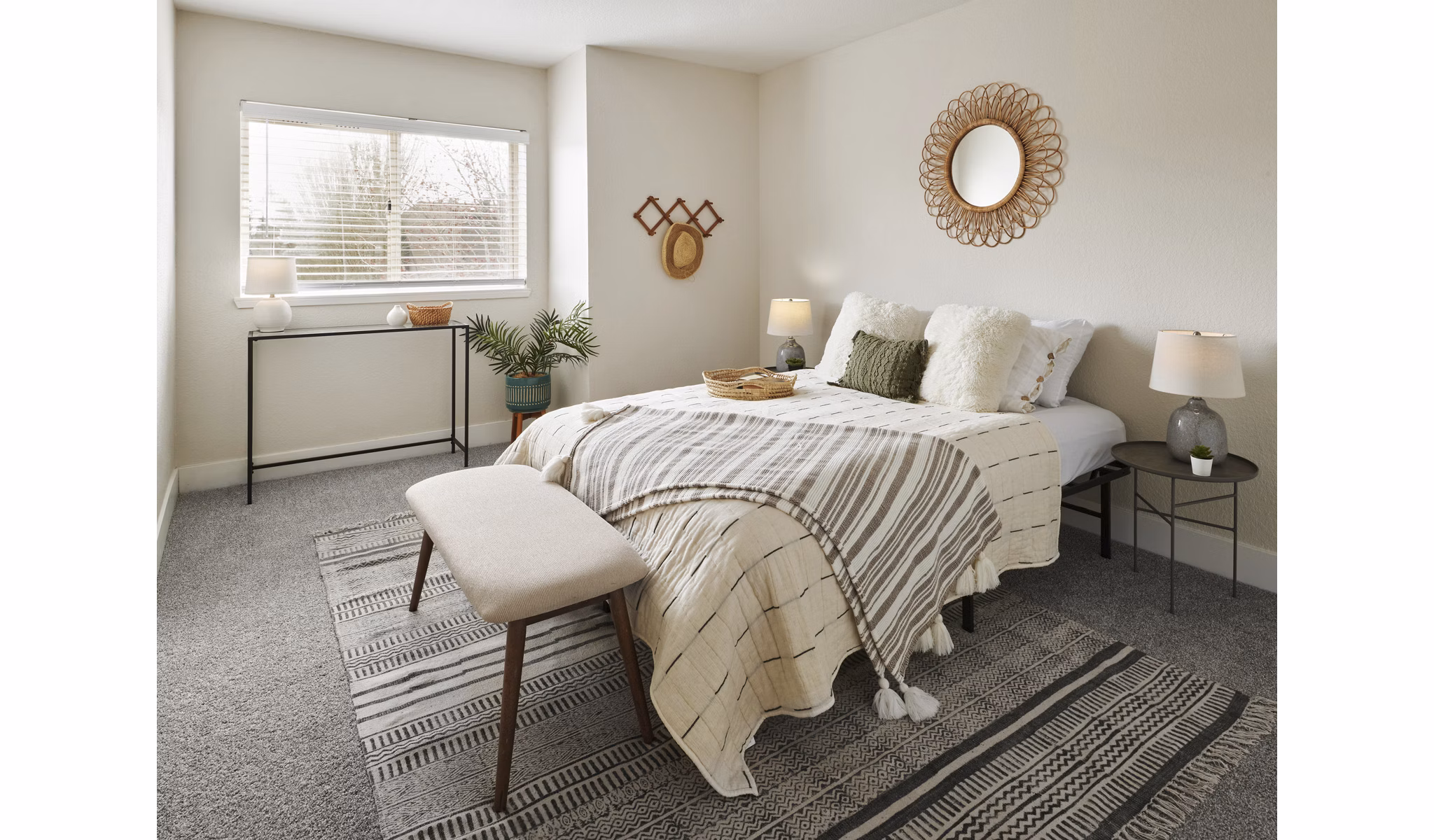 Cozy bedroom with modern decor and neutral tones at The Woodlands Apartments