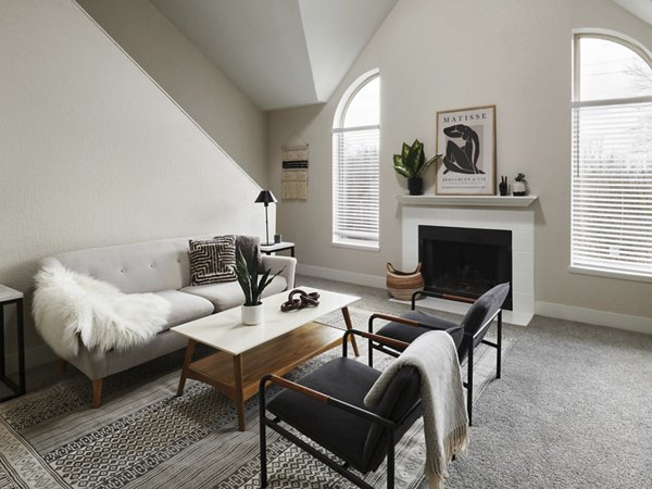 Contemporary living room with large windows at The Woodlands Apartments