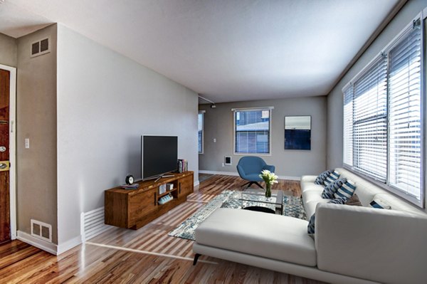 Cozy living room with modern decor and large windows at Lock Vista Apartments