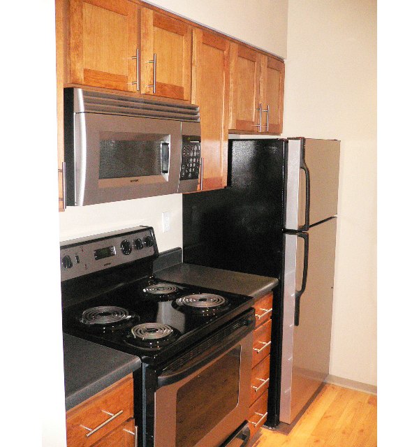 Spacious kitchen with modern appliances in Post Alley Court Apartments, perfect for culinary enthusiasts who appreciate luxury living