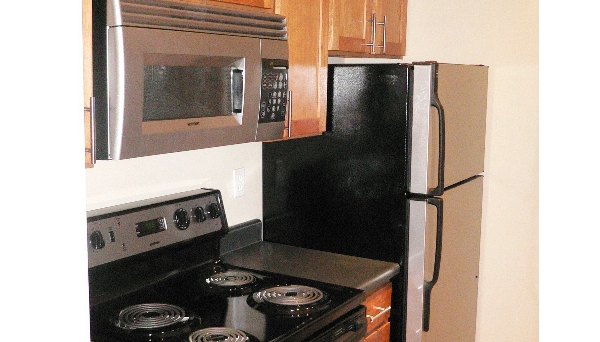 Modern kitchen with stainless steel appliances at Post Alley Court Apartments, offering luxury living in Greystar's Seattle community