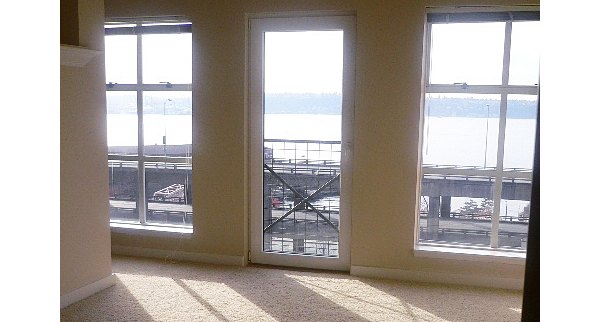Modern living room with sleek furnishings and natural light at Post Alley Court Apartments