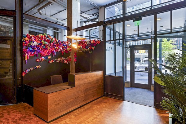 Clubhouse with modern furnishings and open layout at Via 6 Apartments in Seattle, offering luxury amenities for residents