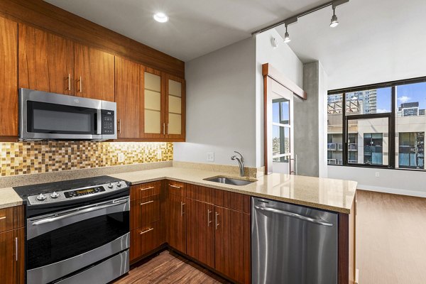 Modern kitchen with stainless steel appliances at Via 6 Apartments
